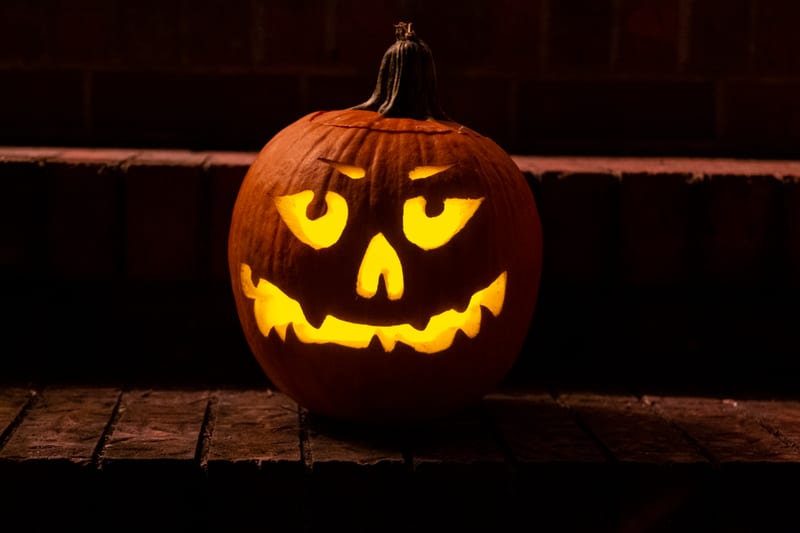 A carved jack-o'-lantern glowing in the dark.